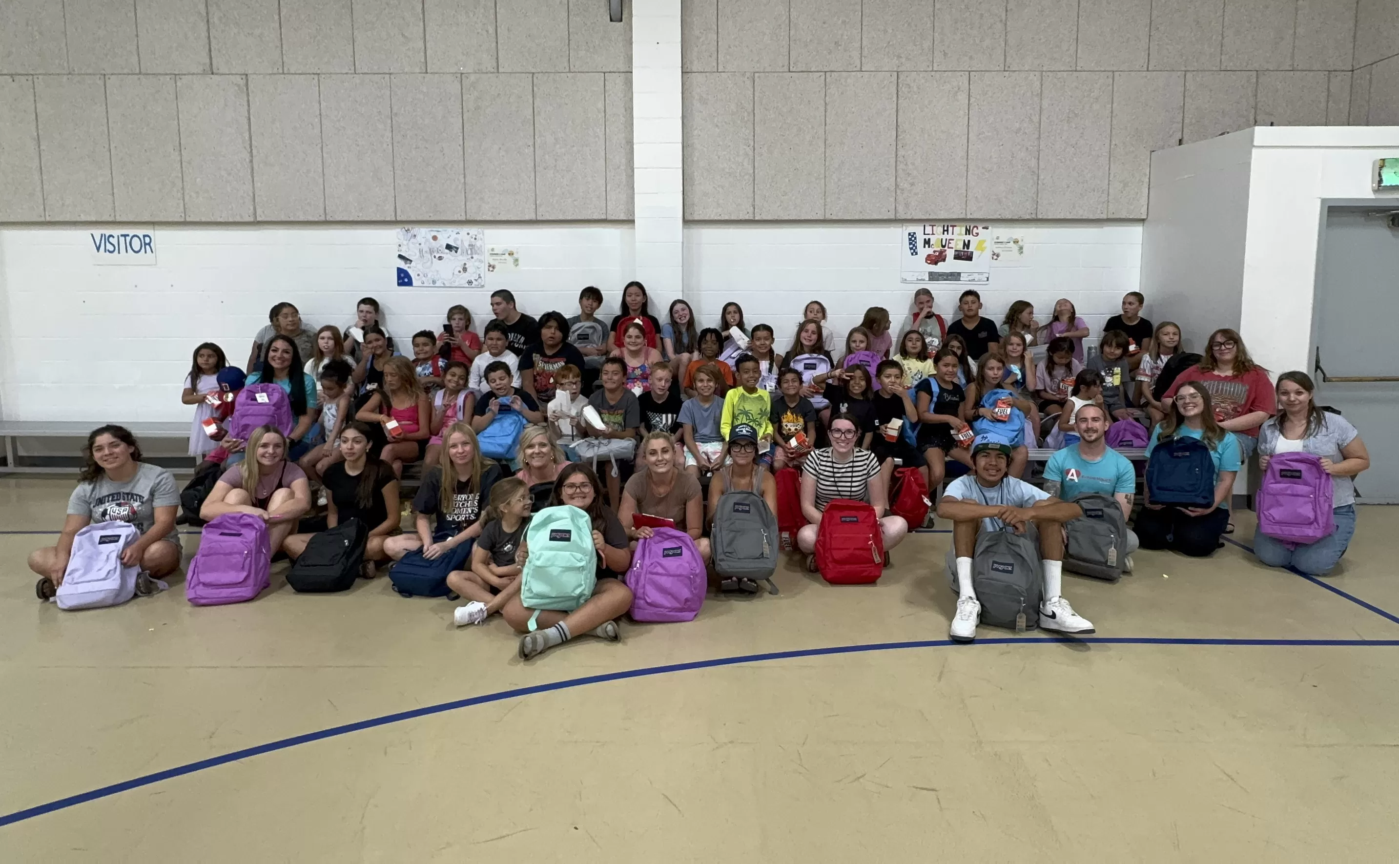 kids receiving backpacks
